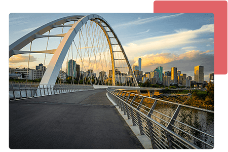 Calgary bridge in front of office buildings with blue sky and clouds - net2phone Canada - Business VoIP Phone System