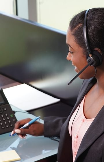 someone talking on a desk phone