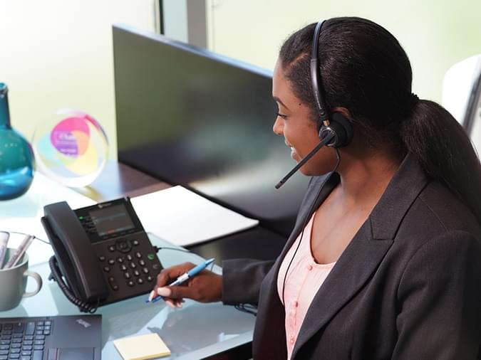 someone talking on a desk phone