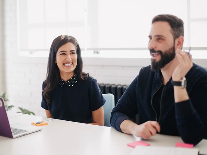 Two people talking in an office