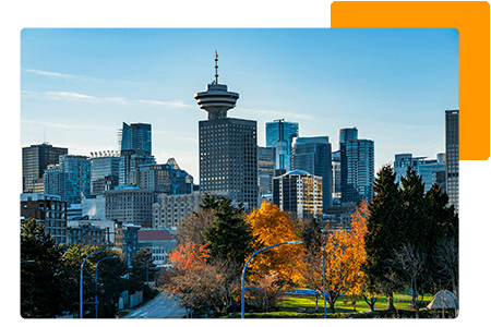 Skyline of British Columbia business buildings behind trees - net2phone Canada - Business VoIP Phone System