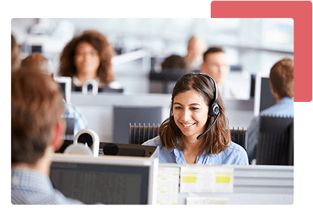 Woman talking into headset at call centre surrounded by employees - net2phone Canada - Business VoIP Phone System