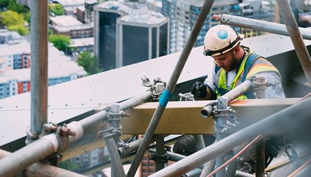 Construction worker on scaffold - D Grant Case Study- net2phone Canada - Business VoIP Phone System
