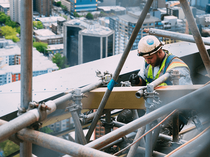 Construction worker on scaffold - D Grant Case Study- net2phone Canada - Business VoIP Phone System