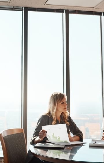 Group of people sitting at table with windows in background - net2phone Canada - Business VoIP Phone System