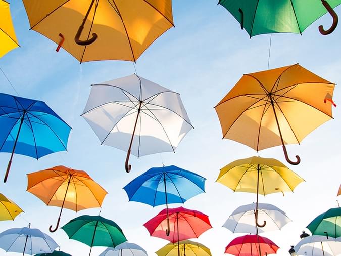 insurance brokers, a photo of umbrellas protecting people below