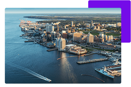 maritimes waterfront cityscape with boat gliding through water