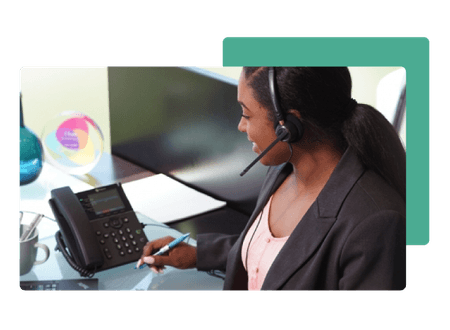 woman wearing phone headset holding pen with poly phone  - net2phone Canada - Business VoIP Phone System