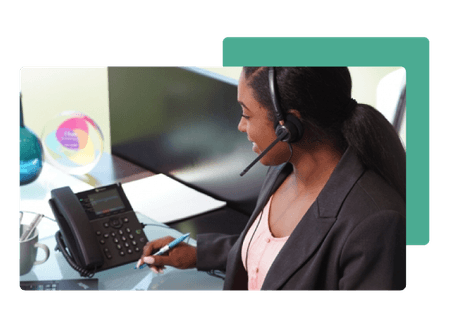 woman wearing phone headset holding pen with poly phone - net2phone Canada - Business VoIP Phone System