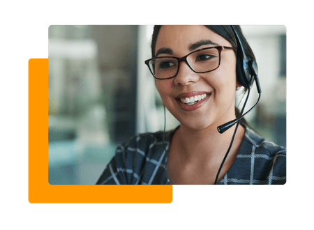 woman wearing glasses and headset smiling - net2phone Canada - Business VoIP Phone System