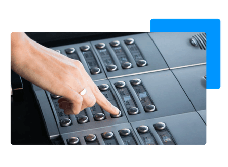 hand pressing buttons on paging phone system - net2phone Canada - Business VoIP Phone System