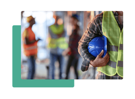 Construction worker holding helmet