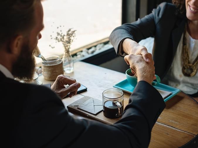 people shaking hands at a meeting