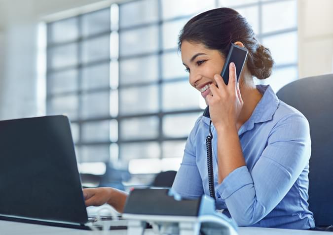 Woman on a desk phone