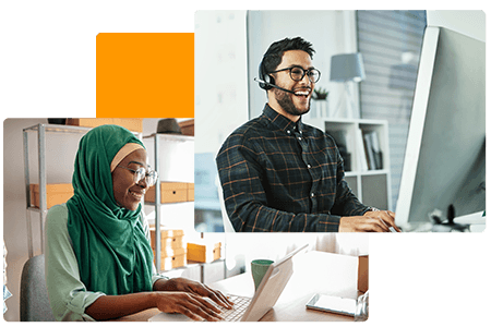 woman and man sitting at computers smiling