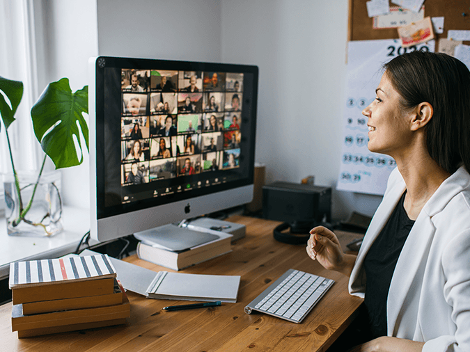 A woman on a video conference call at her desk