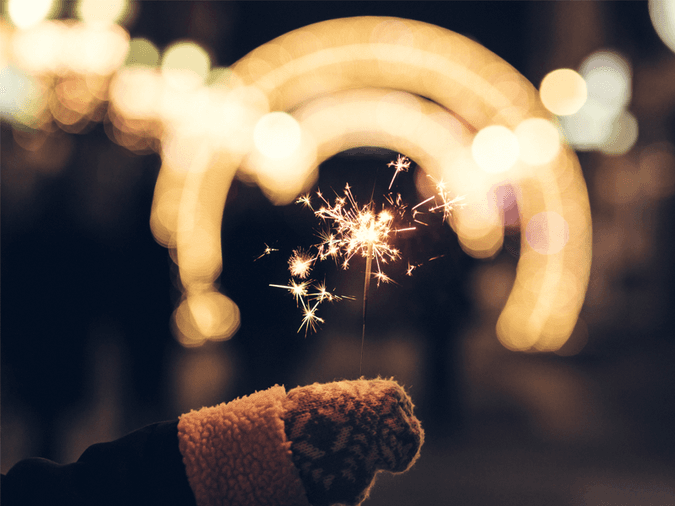 Sparkler held by a child with a glove on - net2phone Canada - Business VoIP Phone System