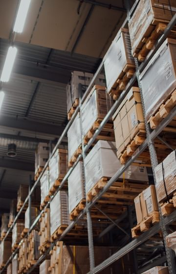 warehouse aisle with boxes stacked on metal racks