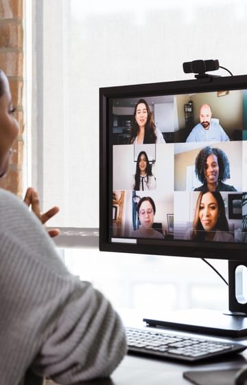 Woman speaking in a virtual video conference - computer conference - net2phone Canada - Business VoIP Phone System