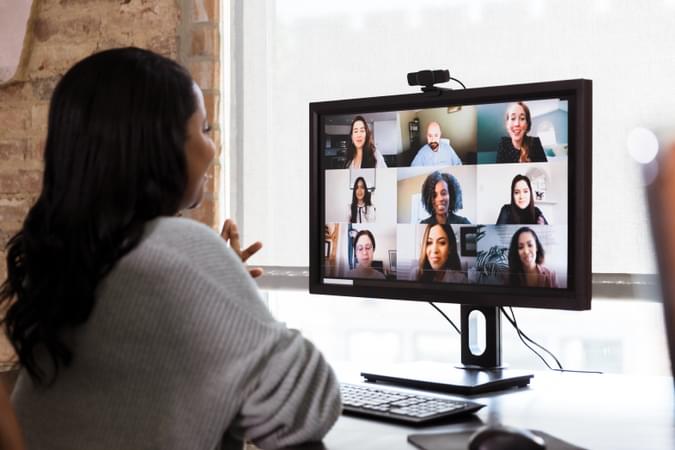 Woman speaking in a virtual video conference - computer conference - net2phone Canada - Business VoIP Phone System