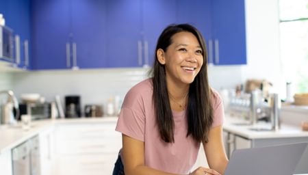 Woman smiling at computer