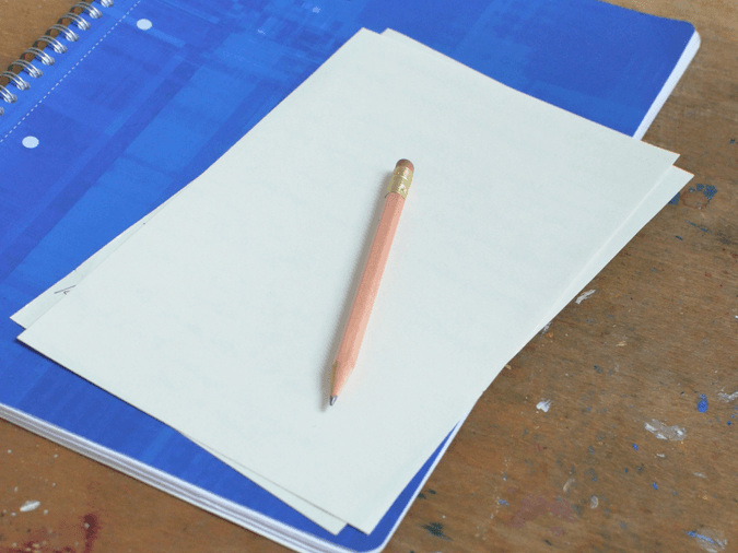 Notebook with paper and a pencil