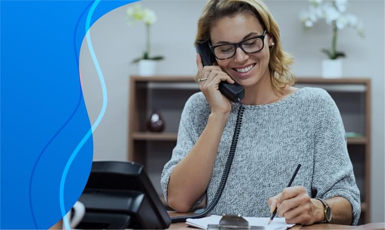 woman-using-voip-phone-at-desk