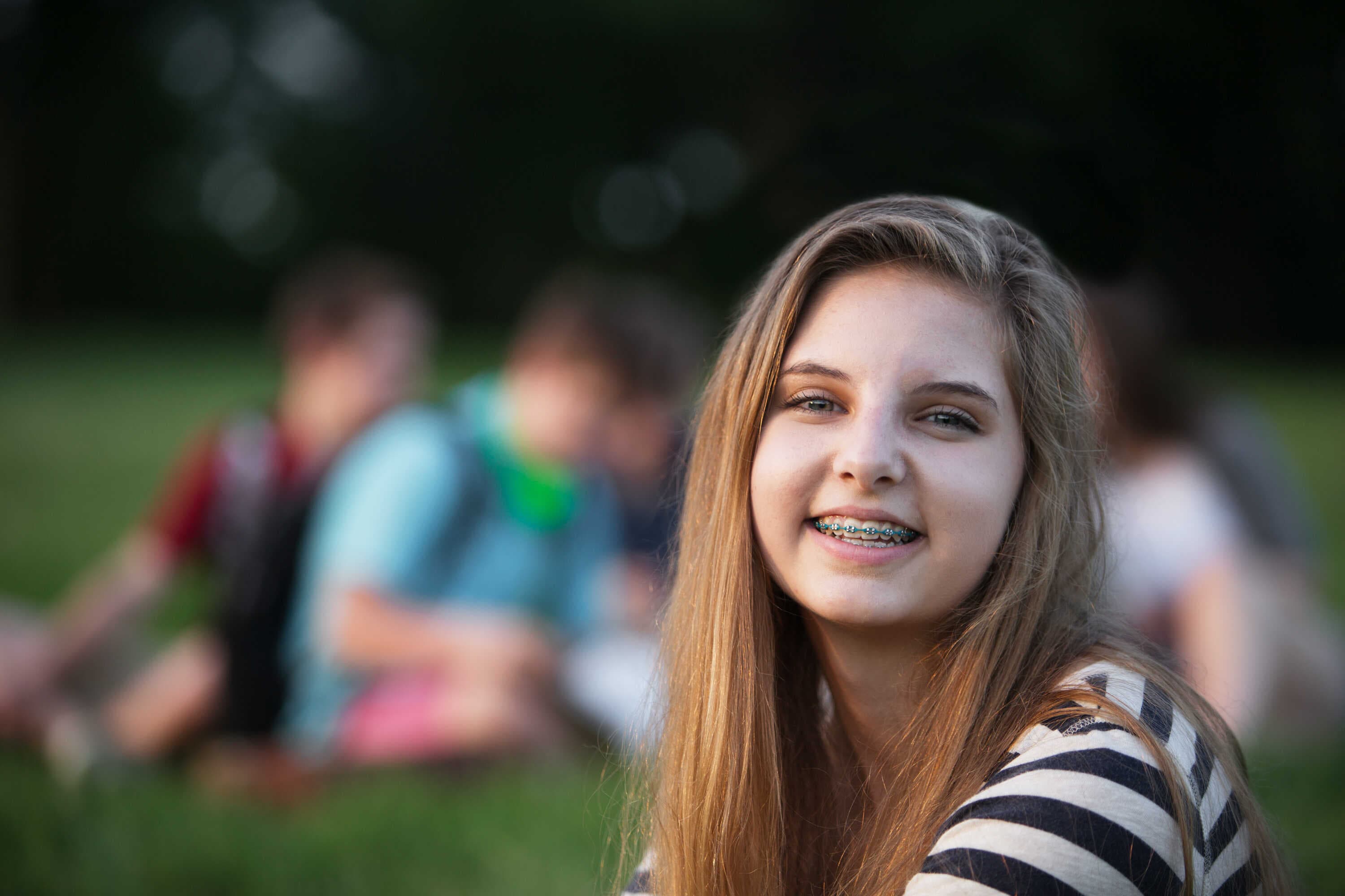 Girl Smiling with Braces at Park