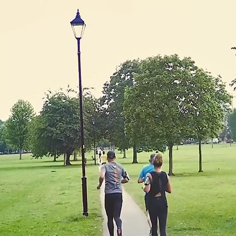 runners on a footpath in a park
