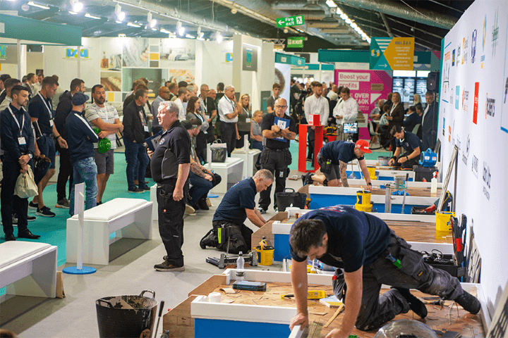 Visitors watch demos at a busy corner at the Harrogate Flooring Show