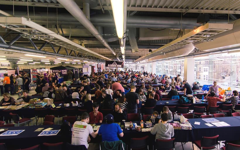 Groups of AireCon attendees play board games