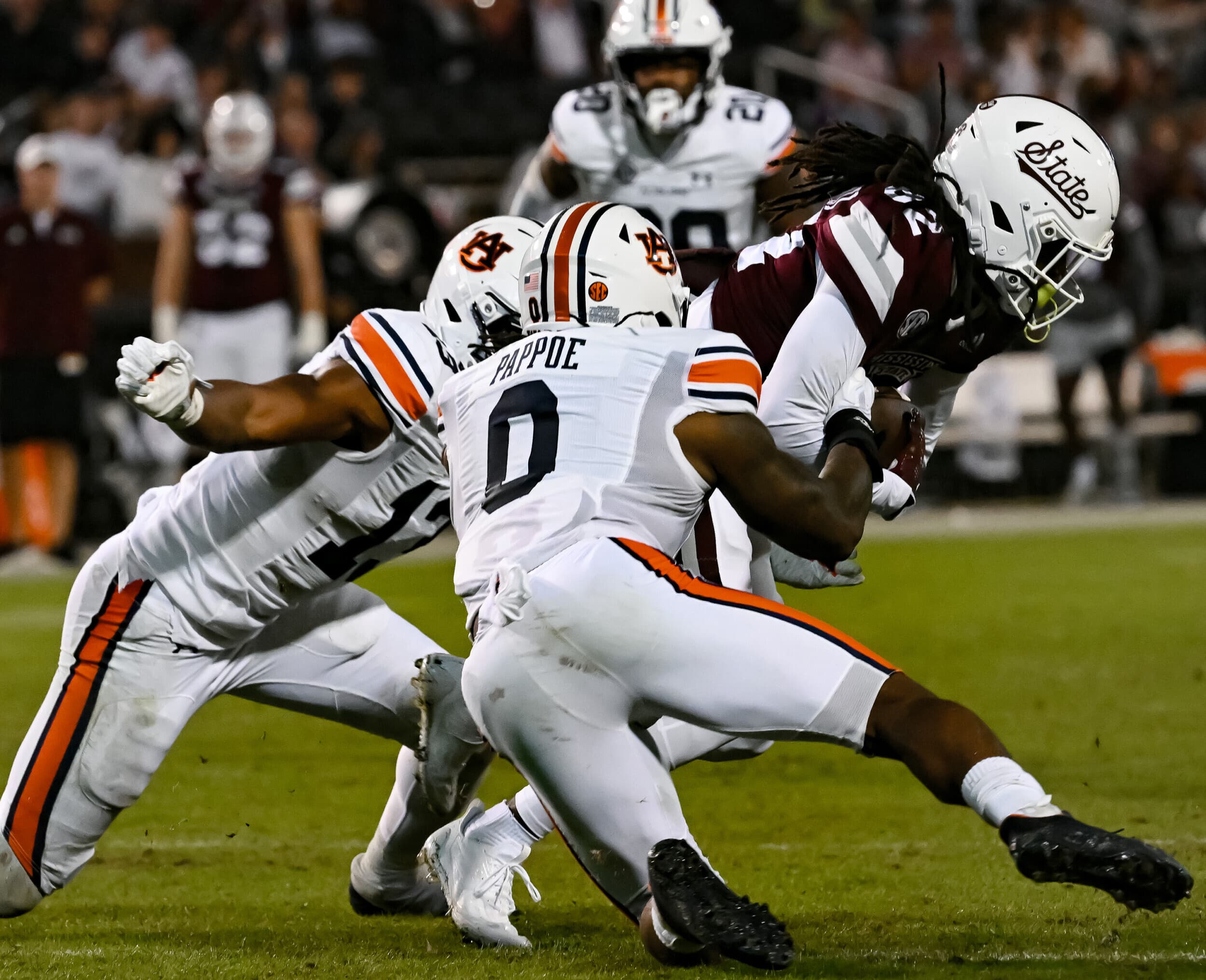 Starkville, MS, USA; Owen Pappoe (0) and Cam Riley (13) tackle MSU offense between Auburn and Mississippi State at Davis Wade Stadium .