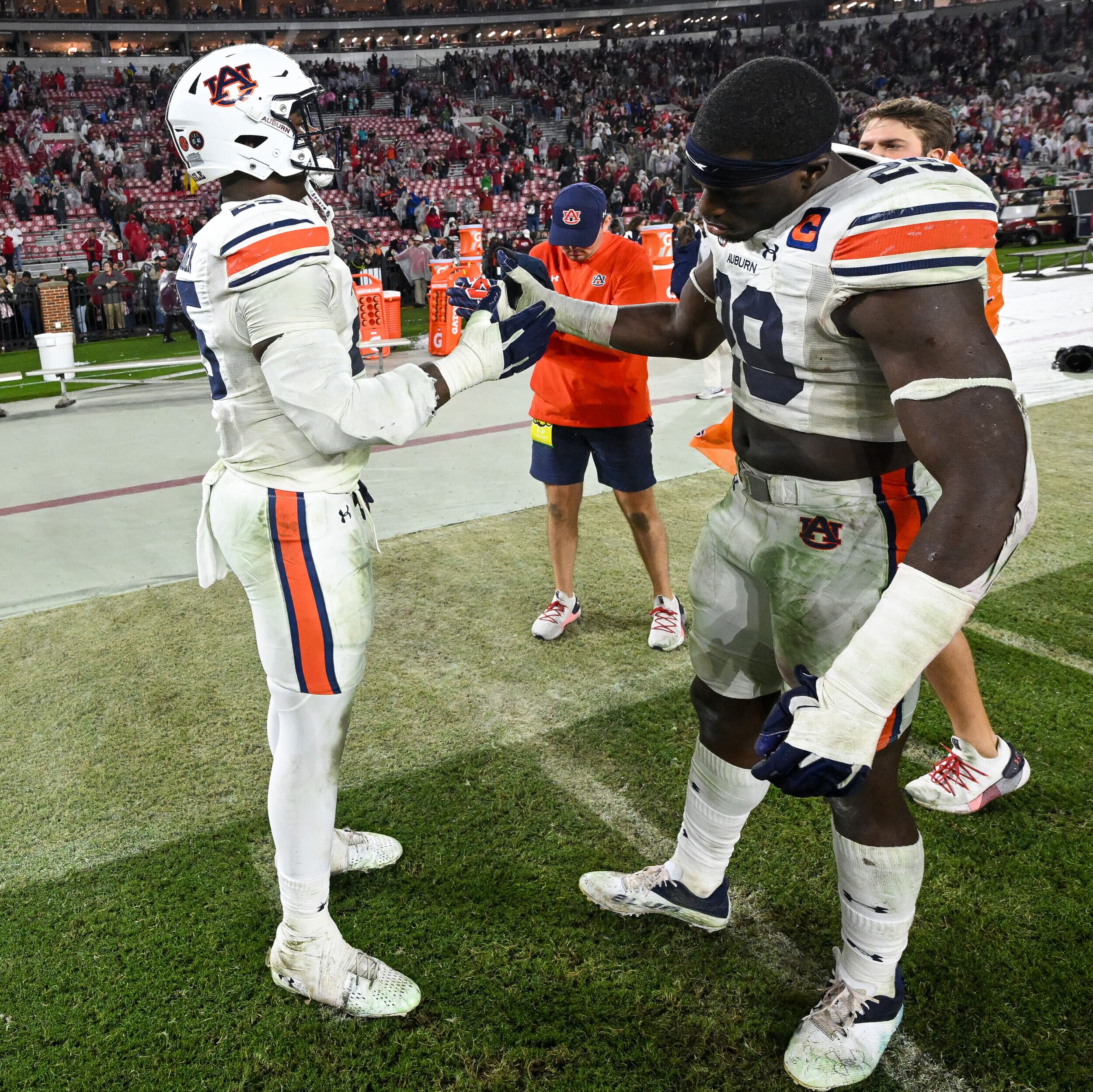 Colby Wooden (25) and Derick Hall (29) share a moment after the game. Auburn vs Alabama  on Saturday, Nov. 26, 2022 in Tuscaloosa, Ala. Todd Van Emst/AU Athletics