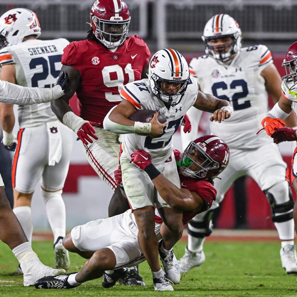 Nov 26, 2022; Tuscaloosa, Al, USA; Jarquez Hunter (27) tries to break the tackle during the game between Auburn and Alabama at Bryant-Denny Stadium.