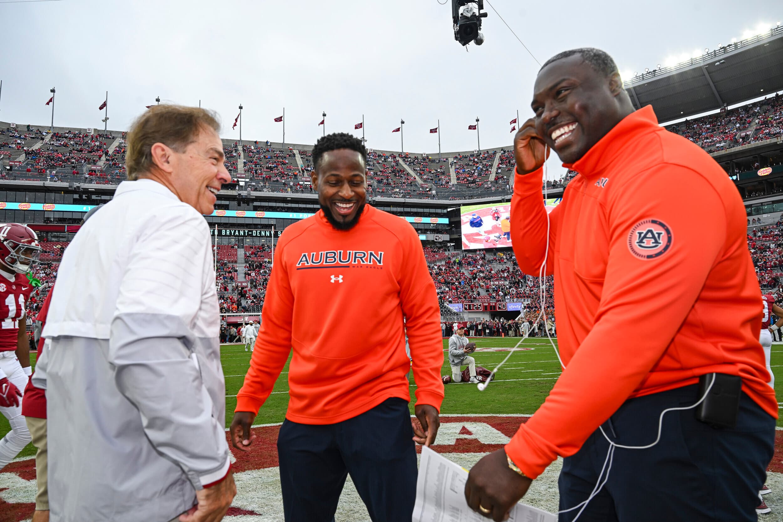 Nov 26, 2022; Tuscaloosa, Al, USA; Coach Carnell Williams, Coach Ronnie Brown talk with Nick Saban before the game between Auburn and Alabama at Bryant-Denny Stadium.