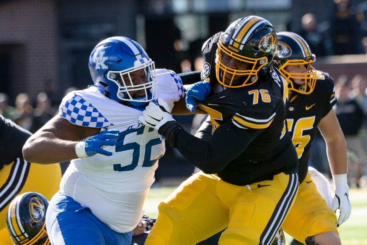 Kentucky defensive lineman Justin Rogers, left, fights his way past Missouri’s Javon Foster, right, during a game Saturday, Nov. 5, 2022, in Columbia, Mo.  L.G. Patterson