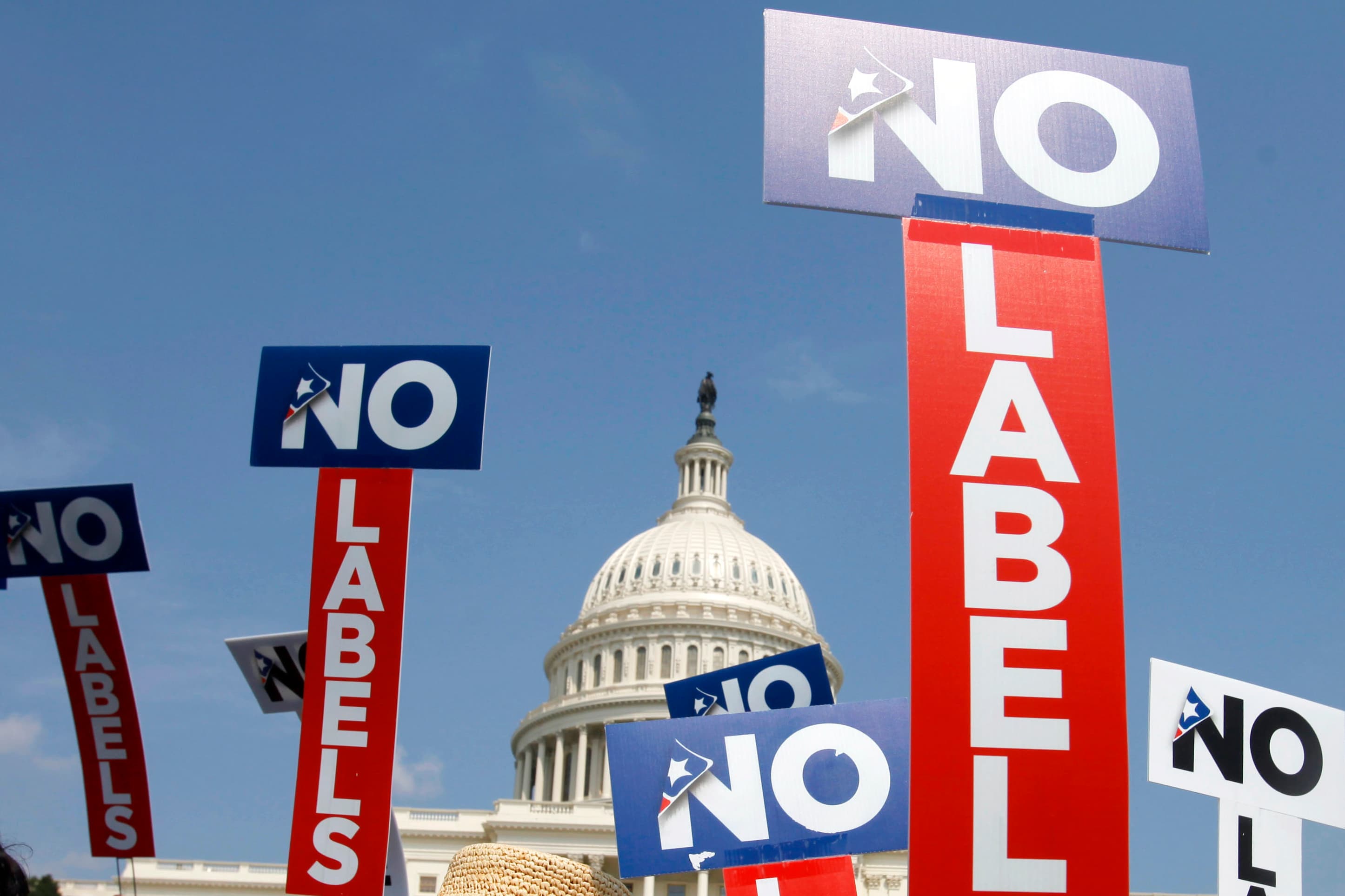 People with the group No Labels hold signs during a rally on Capitol Hill in Washington, July 18, 2011.