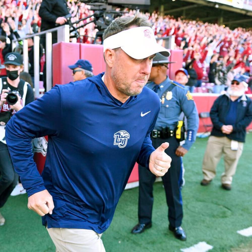 Liberty head coach Hugh Freeze leads his team onto the field to play Arkansas during an NCAA college football game Saturday, Nov. 5, 2022, in Fayetteville, Ark.