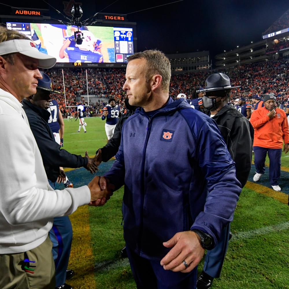 Auburn, AL, USA; Coach Bryan Harsin reacts with Lane Kiffin after the game between Auburn and Ole Miss at Jordan-Hare Stadium.
