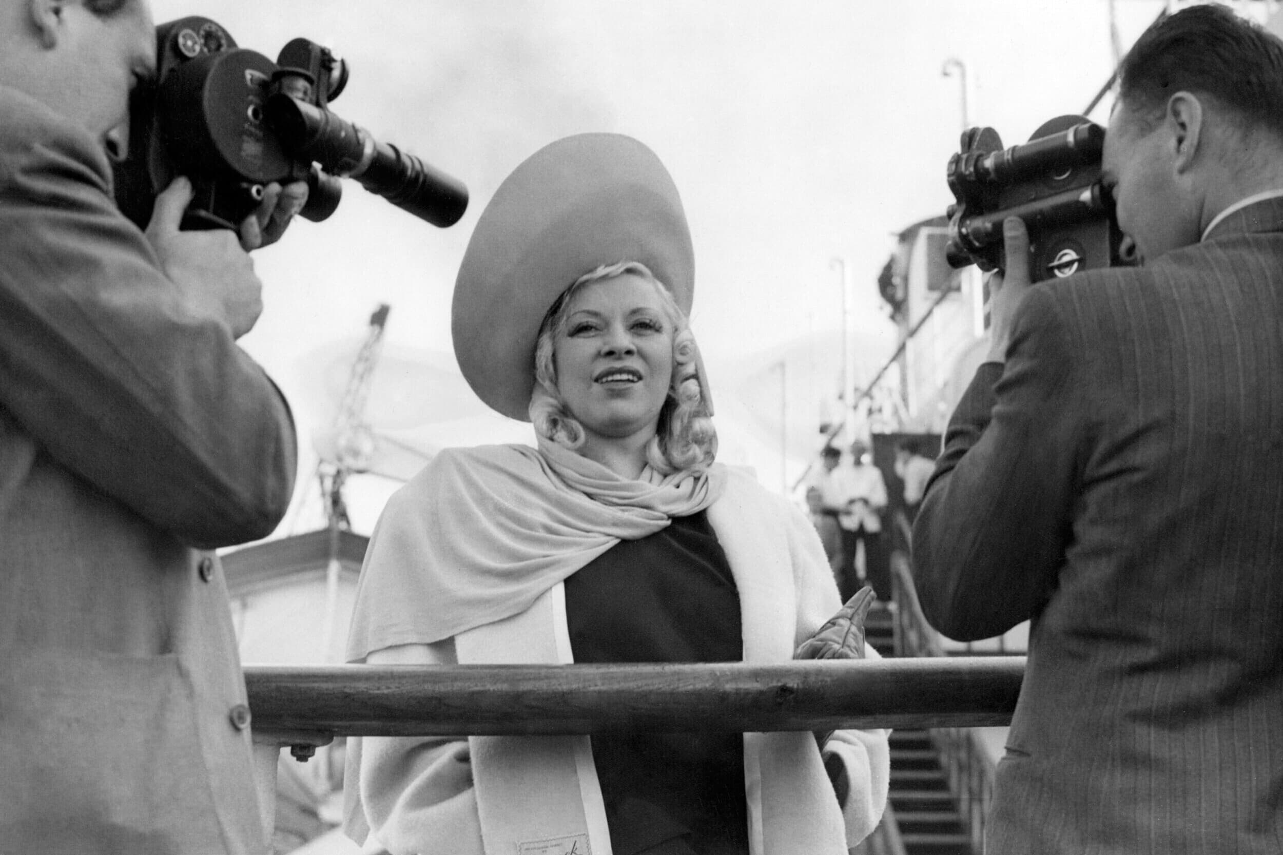 Mae West, who has come to England to star in her first London stage play, her own play Diamond Lil, is seen after her arrival at Southampton on Sept. 17, 1947, aboard the liner Queen Mary from New York.