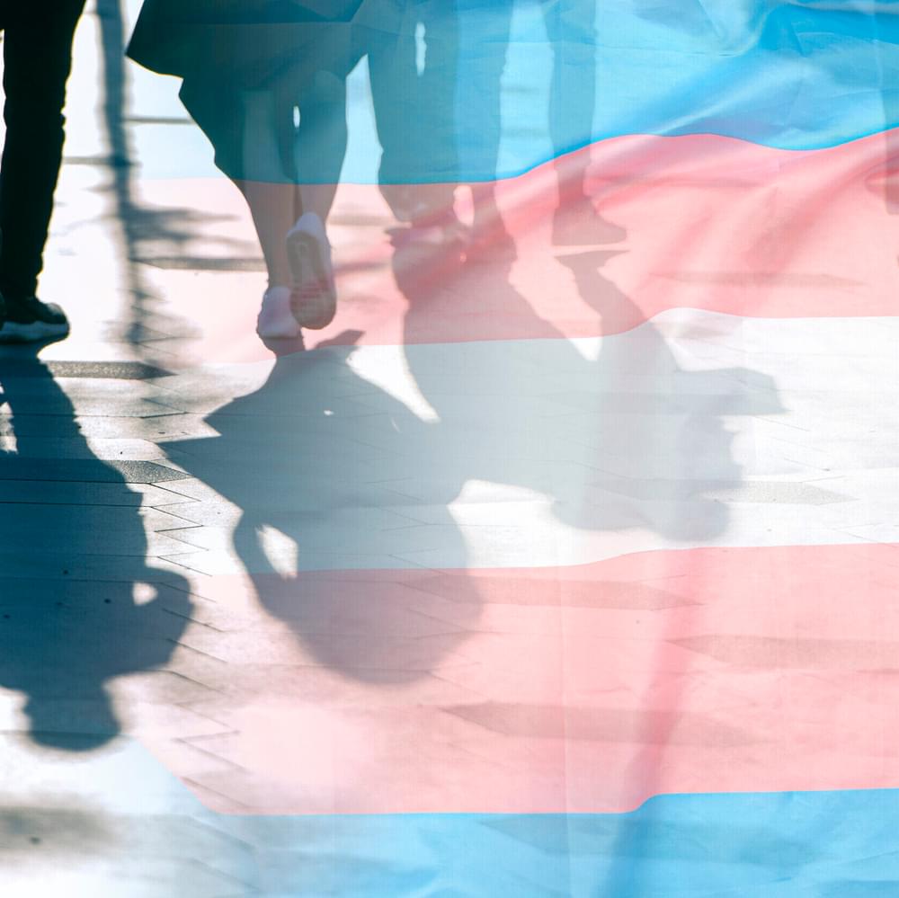 Transgender flag, shadows and silhouettes of people on a road, conceptual picture about anonymous Transgender and Gay Lesbian in the World Alabama News