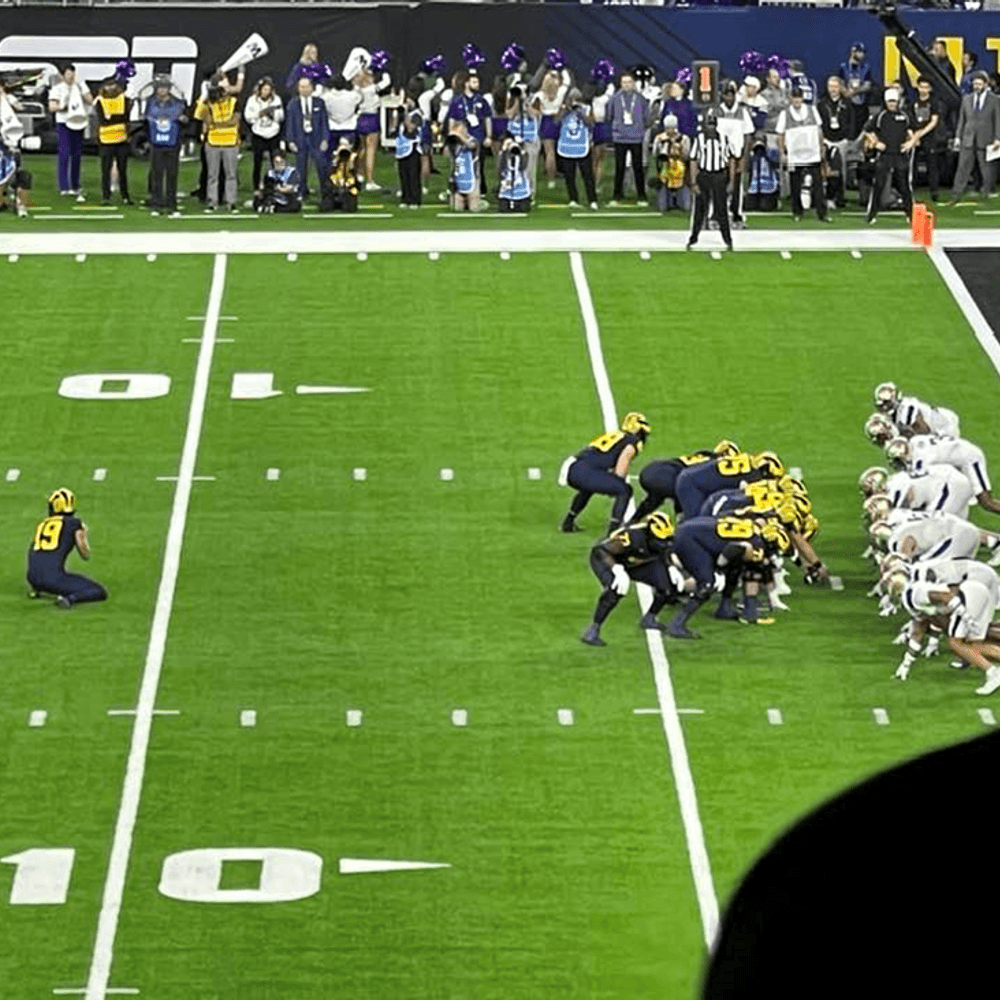 William Wagner snaps from center for Michigan extra point in championship game against Washington. Alabama News