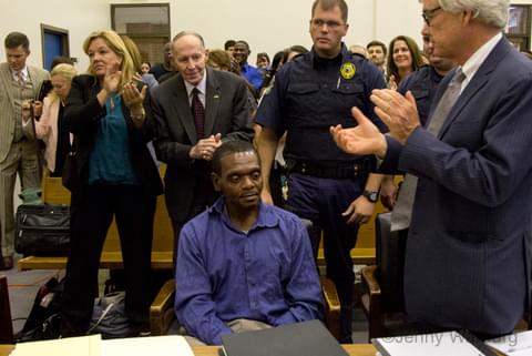 Observers applaud as Henry McCollum is exonerated. Behind Mr. McCollum is I. Beverly Lake, former Chief Justice of the North Carolina Supreme Court and founder of the North Carolina Innocence Inquiry Commission.