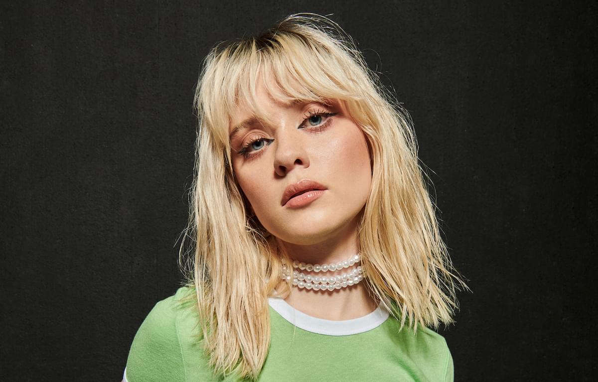 Maisie Peters green top portrait for "Not Another Rockstar"