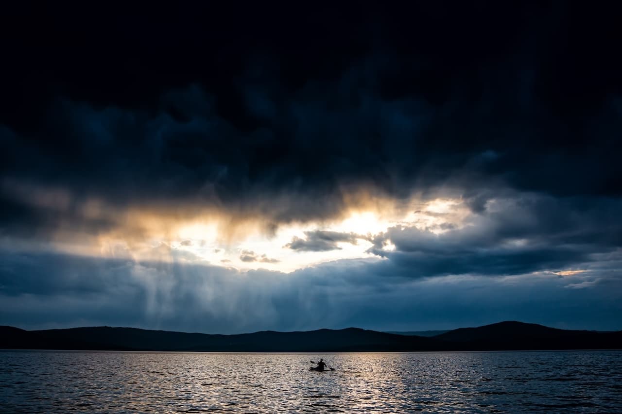 Kayak at sunset stormy