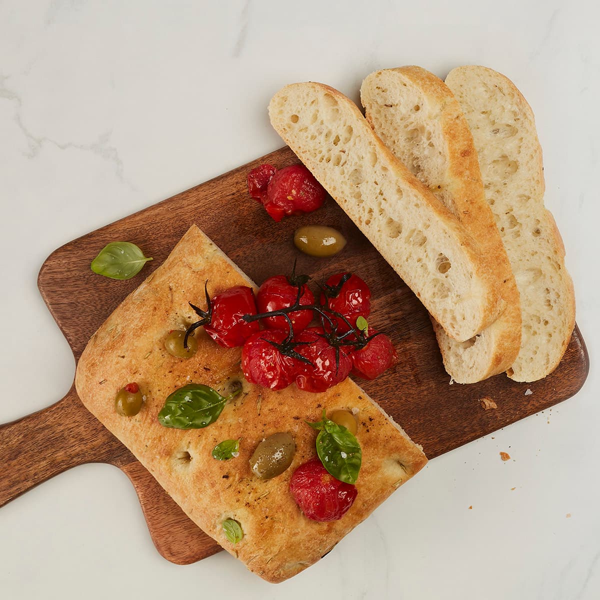 sliced rosemary and olive oil focaccia with olives