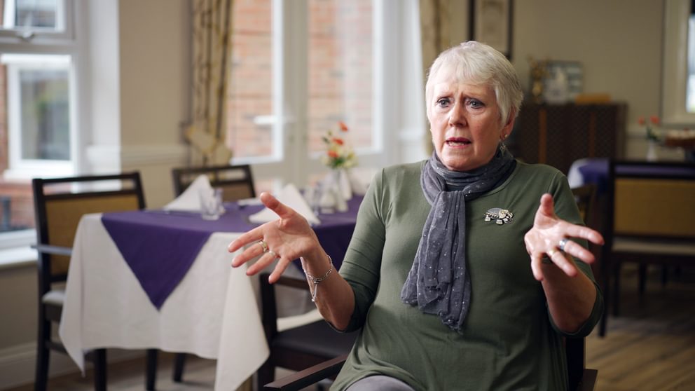 Someone gesturing talking about dementia care.