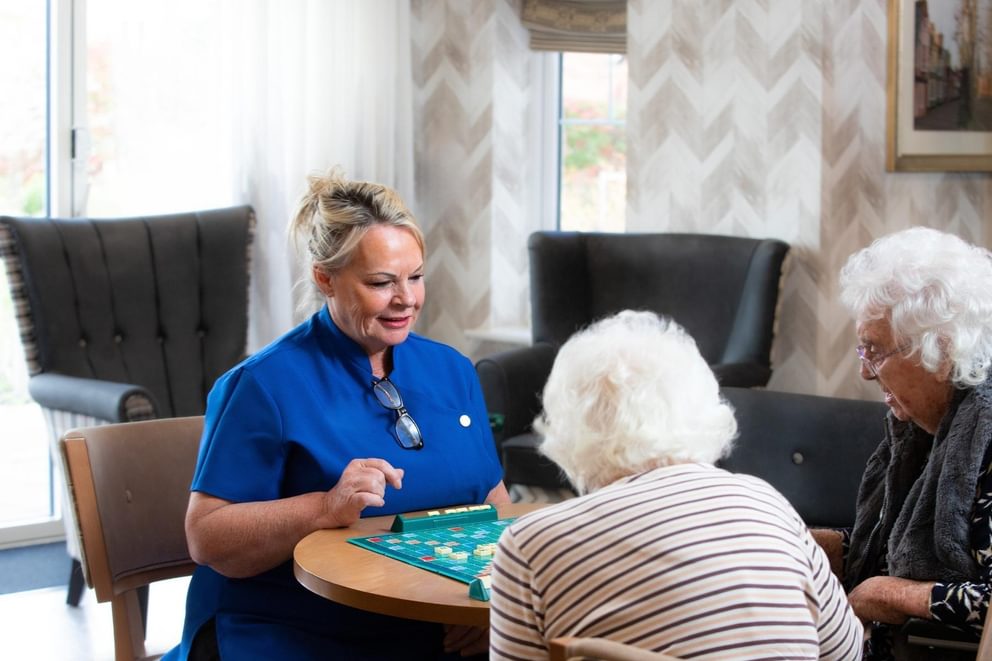 Caring Homes nurse sitting with residents