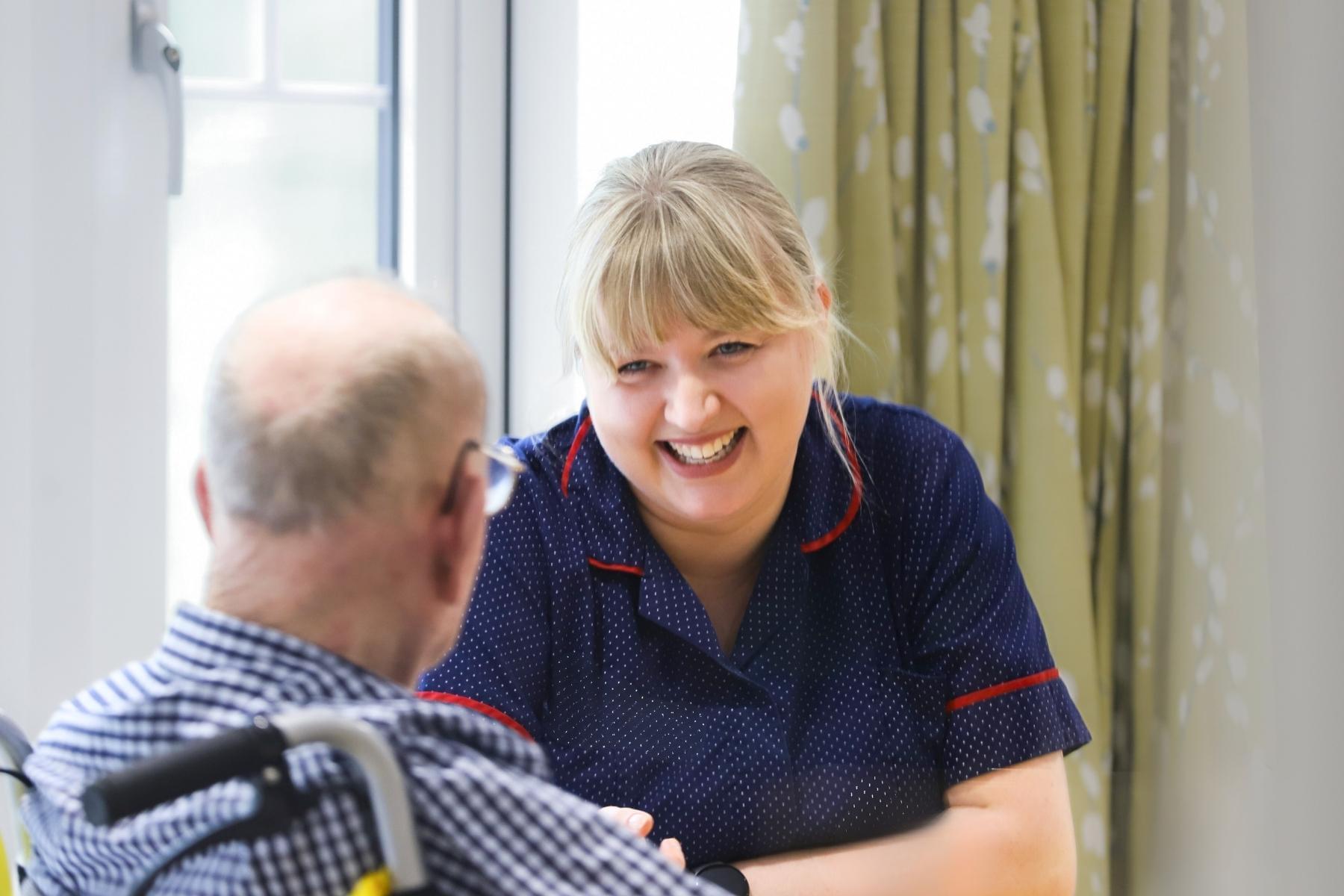 Team member at talks with care home resident