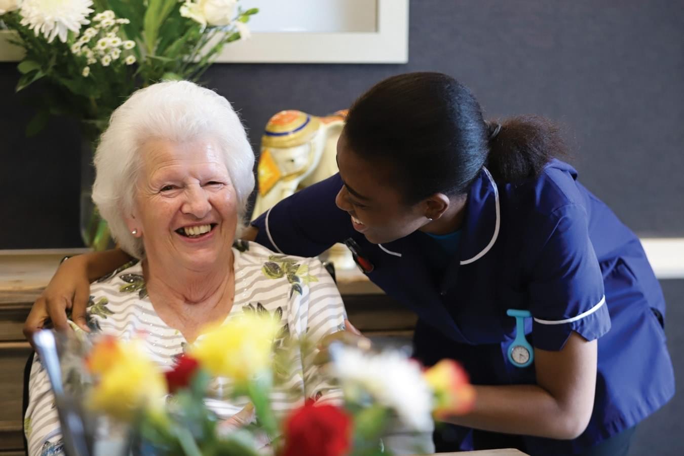 Member of staff at Caring Homes care home caring for elderly resident